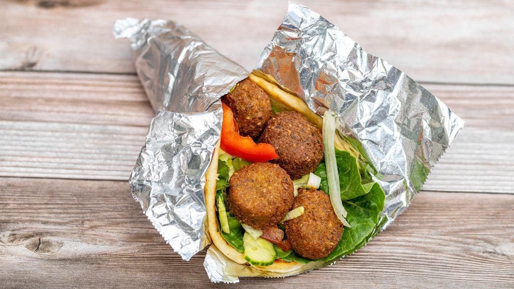 Falafel Sandwich  · Falafel served on house salad and a toasted pita bread with your choice of white sauce and / or hot sauce