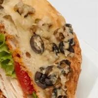 Rosemary Chicken Signature Sandiwch · With roasted peppers, arugula, plum tomatoes and pesto aioli on olive focaccia.