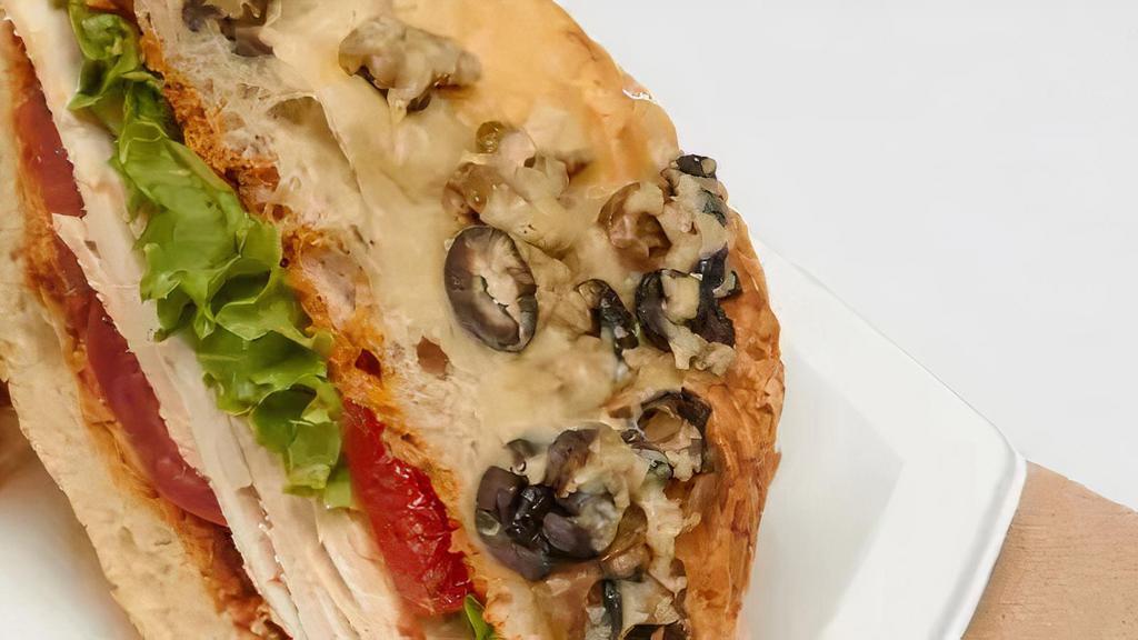 Rosemary Chicken Signature Sandiwch · With roasted peppers, arugula, plum tomatoes and pesto aioli on olive focaccia.