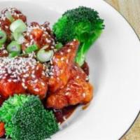 Sesame Chicken · Chicken fried cooked mixed with hot spicy sauce and sesame seeds. garnished with broccoli. c...