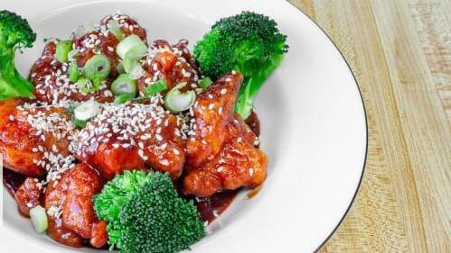 Sesame Chicken · Chicken fried cooked mixed with hot spicy sauce and sesame seeds. garnished with broccoli. comes with white rice.
