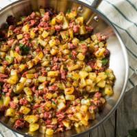 Corned Beef Hash · A delicious dish filled with chopped meat, potatoes, and fried onions.
