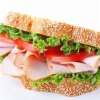 Ovengold Turkey Sandwich · Freshly prepared Oven Gold Turkey sandwich topped with lettuce, tomato, and cheese. Served o...