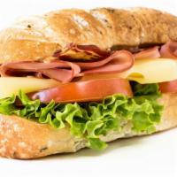 Virginia Ham Sandwich · Freshly prepared Virginia Ham sandwich topped with lettuce, tomato, and cheese. Served on Cu...