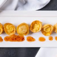 Classic Crab Rangoon · Fresh crab and cream cheese dumplings, red onion, sweet and spicy.