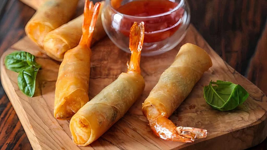Prawn Rolls · Deep-fried shrimp marinated in garlic and pepper wrapped in spring rolls skin and served with sweet chili, garlic sauce.