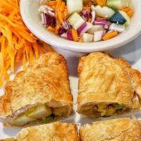 Vegetarian Curry Puffs · Delicious puff pastry with tofu, potato, and onion seasoned with Thai curry, served with cuc...