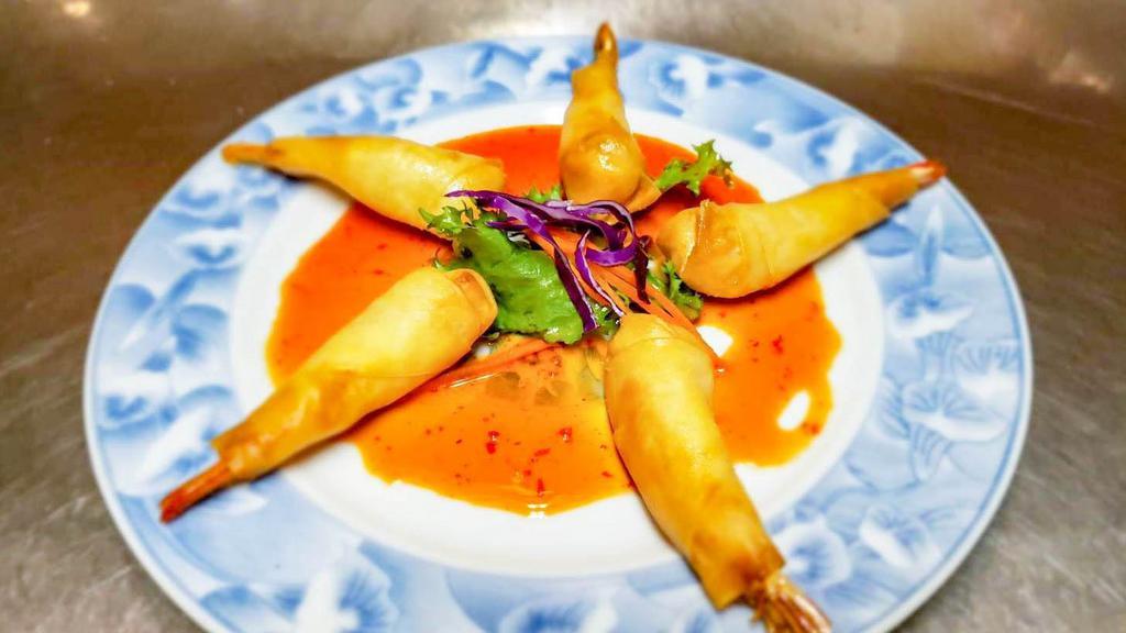 Shrimp In A Blanket · Deep fried shrimp with stuffed shrimp wrapped in a crispy spring roll served with mild spicy sauce.