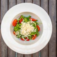 Rucola Salad · Arugula, tomatoes, shaved parmesan and balsamic vinaigrette