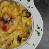 Seafood Pasta · Parpadella pasta, white wine, shallots, heavy cream,Parmesan cheese with shrimp, clams, and ...