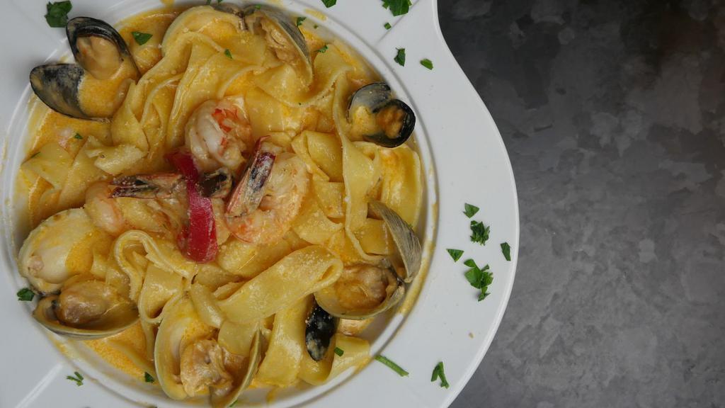 Seafood Pasta · Parpadella pasta, white wine, shallots, heavy cream,Parmesan cheese with shrimp, clams, and mussels.