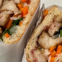Pork Belly Banh Mi · Braised and Caramelized Pork Belly w/ pickled radish/carrots, cucumber, tomatoes, cilantro, ...