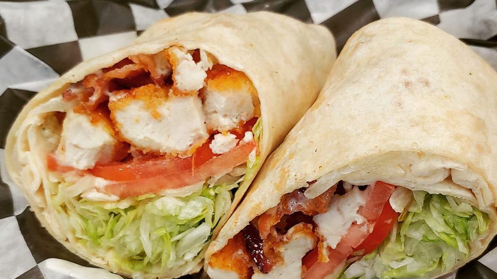 Chicken Ranch Wrap · Crispy Chicken tenders wrapped in a warm tortilla and topped with crispy bacon, fresh lettuce, tomato and ranch dressing.