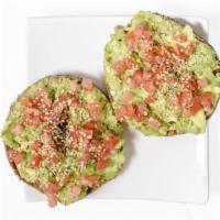 The Avocado Toast · Crushed avocado, diced tomatoes, lemon, everything seeds, salt. and pepper.