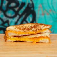Classic Grilled Cheese · Melted american cheese between two slices of buttery grilled bread.