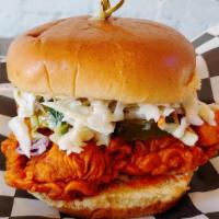 Nashville Hot Chicken Sandwich · Drenched in Nashville Hot Oil with coleslaw and pickle chips.