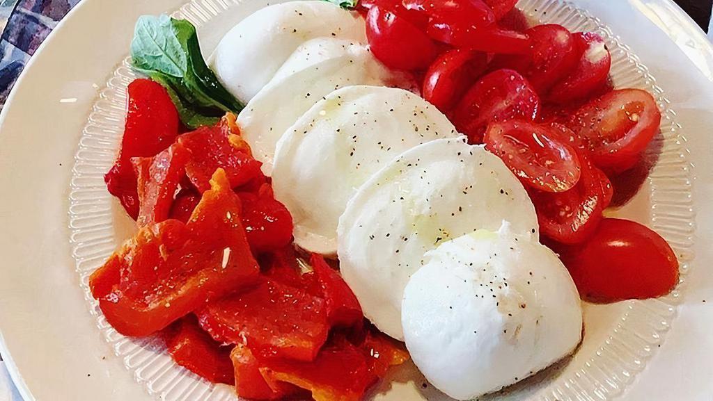 Caprese Salad · Fresh buffalo mozzarella imported from Campagna, Italy, served with wood-fired roasted tomatoes, extra virgin olive oil, and sea salt.
