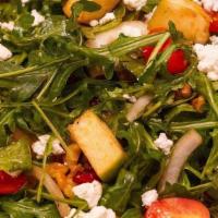 Arugula Salad · Arugula, tomatoes, onions, green apples, cranberries, walnuts, and goat cheese, tossed with ...