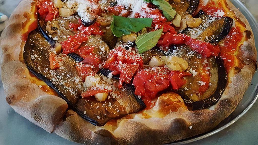 Sicilian Eggplant Pizza (No Mozzarella) · San Marzano tomatoes, garlic, sliced roasted eggplant, garlic roasted eggplant, olive oil, Reggiano, and Pecorino cheese.