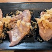 Tuna Tataki (6 Pieces) · Thinly sliced tuna, seared, topped with crunch, and yuzu sauce.