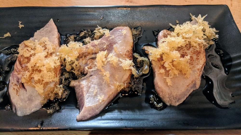 Tuna Tataki (6 Pieces) · Thinly sliced tuna, seared, topped with crunch, and yuzu sauce.