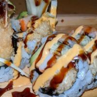 Tiger Roll · Inside shrimp tempura, kani, avocado, and cucumber topped with salmon, eel sauce, and spicy ...