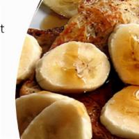 Banana Peanut Butter French Toast · Four slices of egg-washed French toast with banana, peanut butter, maple syrup and butter.