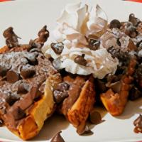 Chocolate Chip Nutella French Toast · Four slices of egg-washed French toast topped with Nutella, chocolate chips, whipped cream, ...
