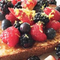 Mixed Berry French Toast · Four slices of egg-washed French toast topped with strawberries, blueberries, whipped cream,...