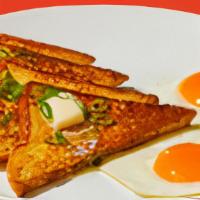 Savory French Toast Plate · Four slices of egg-washed French toast served with two eggs.