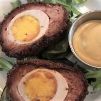 Scotch Egg · Hard-boiled egg wrapped in sausage, breaded & deep fried. Served with a side of spicy mustard
