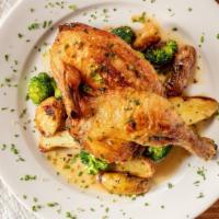Herb Roasted Half Chicken · Served with roasted potatoes and burnt broccoli.