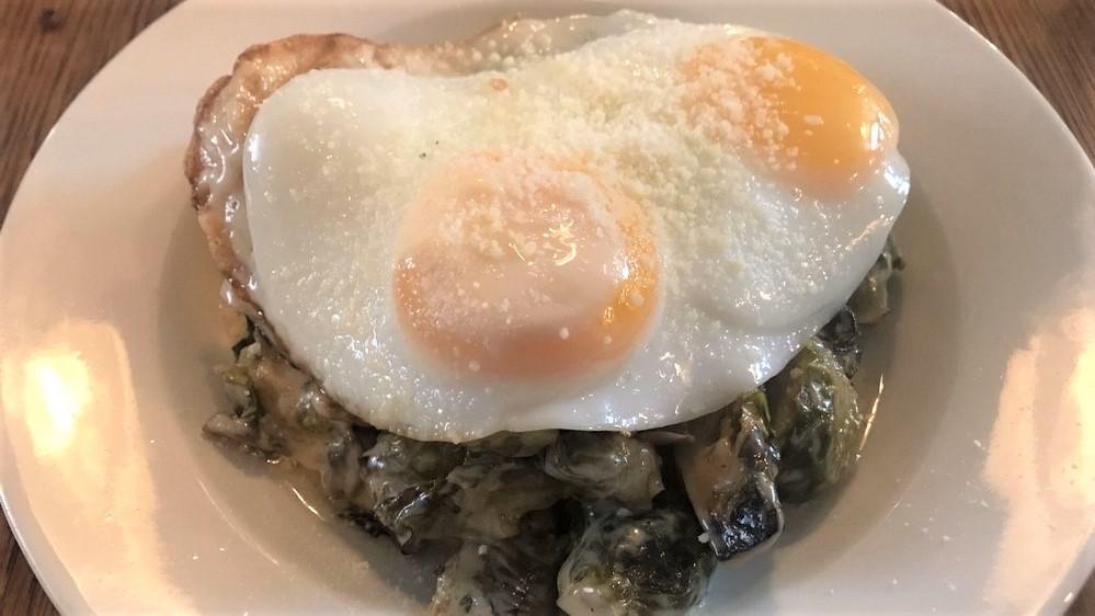 Breakfast Brussels · Caramelized brussel sprouts in a mushroom ragu, 2 sunnyside eggs, and shaved parmesan