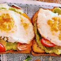 Avocado Toast · Fresh avocado on sourdough. Topped with grape tomatoes, crumbled goat cheese, bacon, & 2 egg...