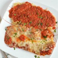 Eggplant Parmigiana · Battered and fried eggplant with tomato sauce, mozzarella cheese and parmesan