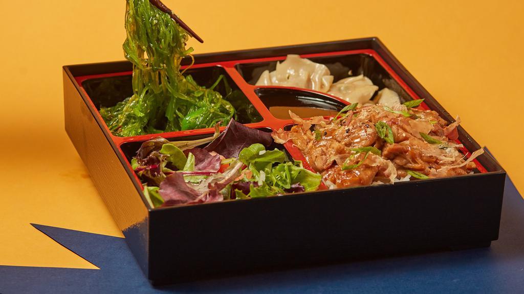 Chicken Bento Box · Served with steamed rice, 3 pieces fried dumplings, seaweed salad and garden salad.