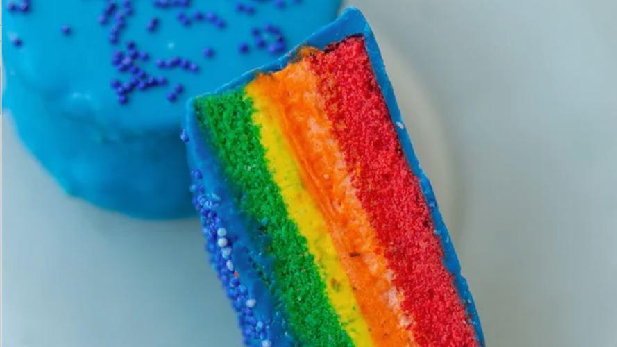 Rainbow · The PRIDE of the Ring Ding Bar. This rainbow almond pound cake features multi-colored layers of creamy vanilla filling, all dipped in blue chocolate. Our snack cakes are for everyone!

Box of 6

Ingredients: Sugar, butter whole eggs, egg whites, Cake flour, almond paste, vegetable shortening, red food color, green food color, yellow food color, orange food color, blue food color, vanilla, salt.