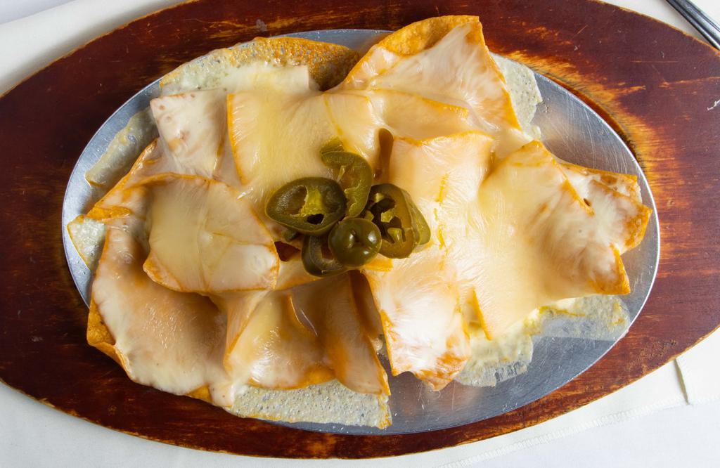 Nachos · Tortilla chips covered with melted cheese and topped with jalapeños.