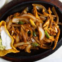 Tacos Al Carbon (Sizzling Fajitas) · Marinated and charbroiled fillings served with piping hot flour tortillas to make your own s...