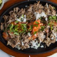 Carnitas · Delicious pork marinated in garlic, pepper, and tequila. Served with piping hot flour or cor...