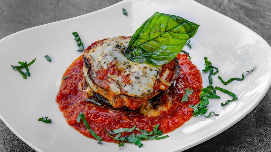 Eggplant Parmigiana Fried · Served with tomato sauce mozzarella with and basil.