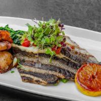 Whole Filet Branzino · Served with broccoli rabe and fingerling potatoes.