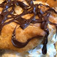 French Cream Puff · Pate a choux with bavarian cream, drizzled with chocolate.