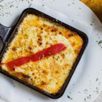 Provoleta · Grilled provolone cheese topped with extra virgin olive oil, and oregano.