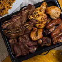 Parillada Americana · Skirt steak, flap steak, pork loin, Italian sausage, short ribs, chicken.