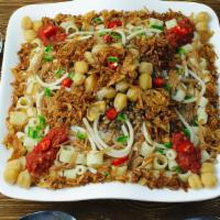 Kushari كشري · Layers of Medium grain rice, paste, lentil, chickpeas, garlic, strong vinegar, tomato sauce,...
