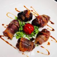 Bacon Wrapped Dates · Medjool dates wrapped in applewood smoked bacon stuffed with roasted pecans.