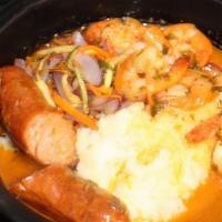 Chorizo Con Camarones · Spanish chorizo, shrimp, cooked in garlic white wine sauce, served over mashed potatoes and ...