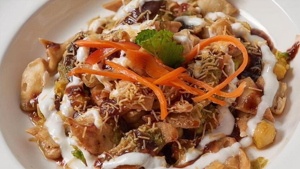 Aloo Papri Chaat · Chopped potato and fried crisps topped with masala chickpeas, yogurt, tamarind and mint sauces.