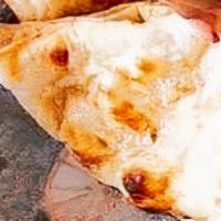 Plain Naan · Handmade bread made in the tandoor, smeared with butter.